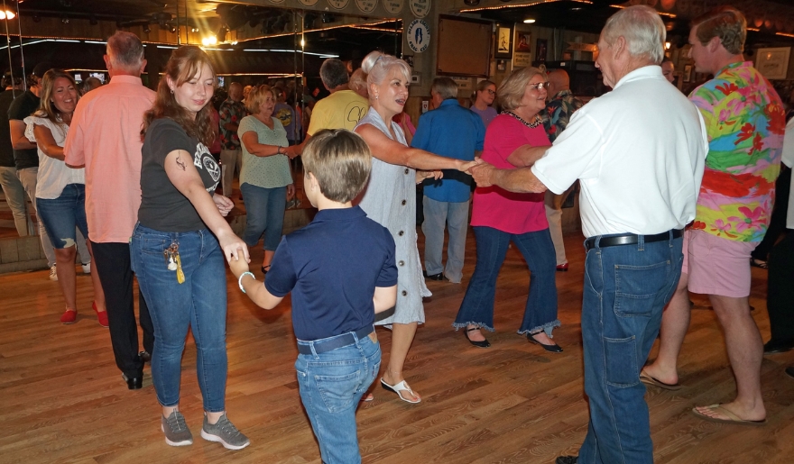 A lively group of people dancing joyfully in the vibrant atmosphere of Fat Harold’s Beach Club in Myrtle Beach.