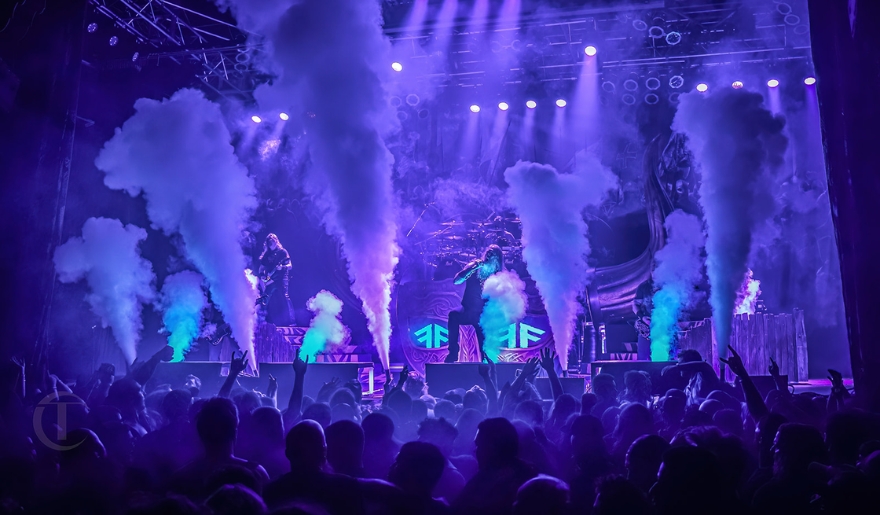 A band performs on stage at House of Blues Myrtle Beach, surrounded by smoke, creating an electrifying atmosphere.