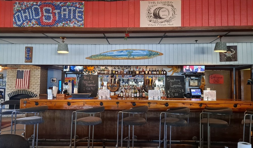 A vibrant beach house bar at The Barrel Sports Bar & Grill, showcasing Myrtle Beach's lively nightlife atmosphere.