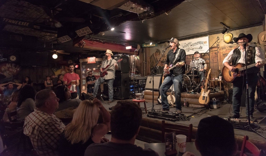 A lively band performs at The Bowery in Myrtle Beach, with an engaged audience enjoying the vibrant nightlife atmosphere.