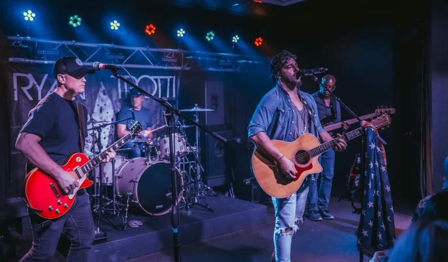 A band captivates the audience on stage at The Landing at the Boathouse, highlighting the energetic atmosphere of Myrtle Beach nightlife.