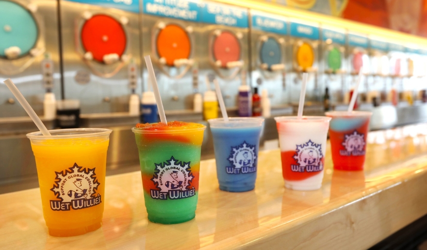 A vibrant array of colorful drinks displayed on a counter at Wet Willie’s in Myrtle Beach, perfect for nightlife experience.