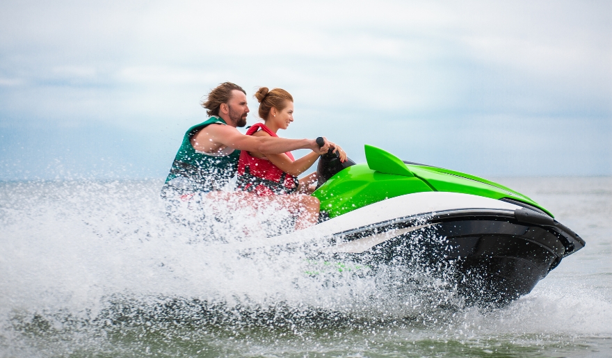A couple enjoying a thrilling jet ski ride together on their honeymoon in Myrtle Beach.