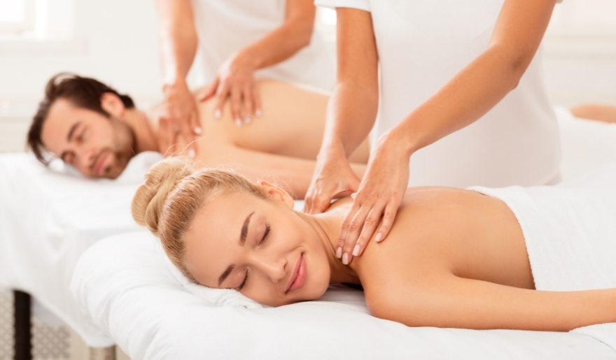A couple enjoying a relaxing massage together in a serene spa setting during their honeymoon in Myrtle Beach.