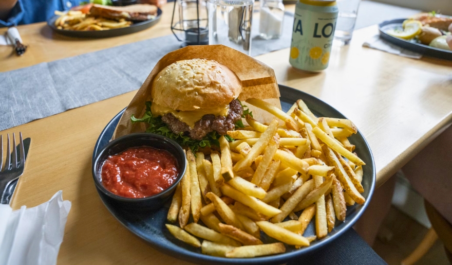 A delicious burger and fries on a plate, highlighting the dining experience at Moe Moon’s, Myrtle Beach nightlife.