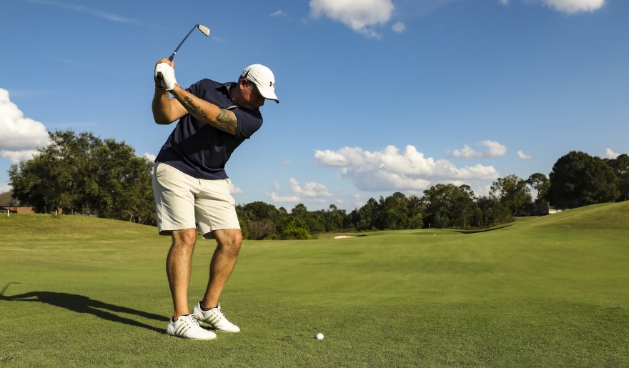 A man takes a swing on a golf course in Myrtle Beach, capturing the essence of September golfing.