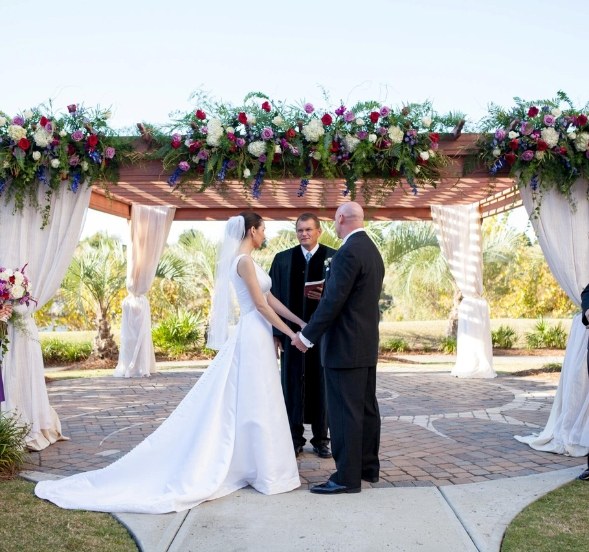 A wedding ceremony taking place at Marina Inn in Myrtle Beach, SC with decorated altar.