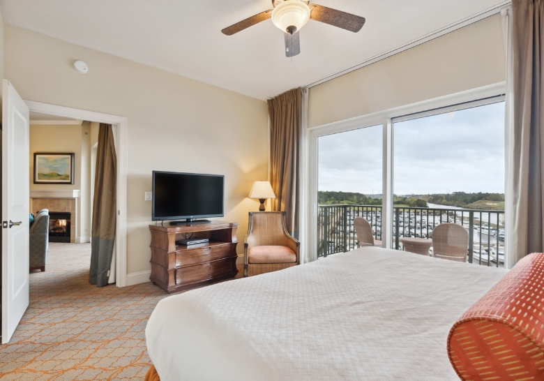 A cozy bedroom featuring a large bed and a television, ideal for overnight stays during birthday parties in Myrtle Beach, SC.