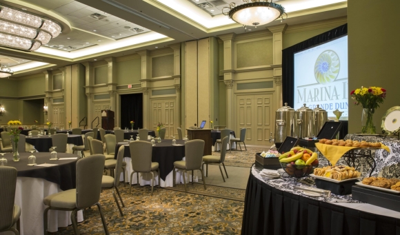 A banquet room in North Myrtle Beach, SC, with tables and chairs organized for an upcoming presentation.