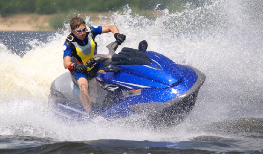 A man on a jet ski skimming across the water, embodying the thrill of adventure during holidays in Myrtle Beach.