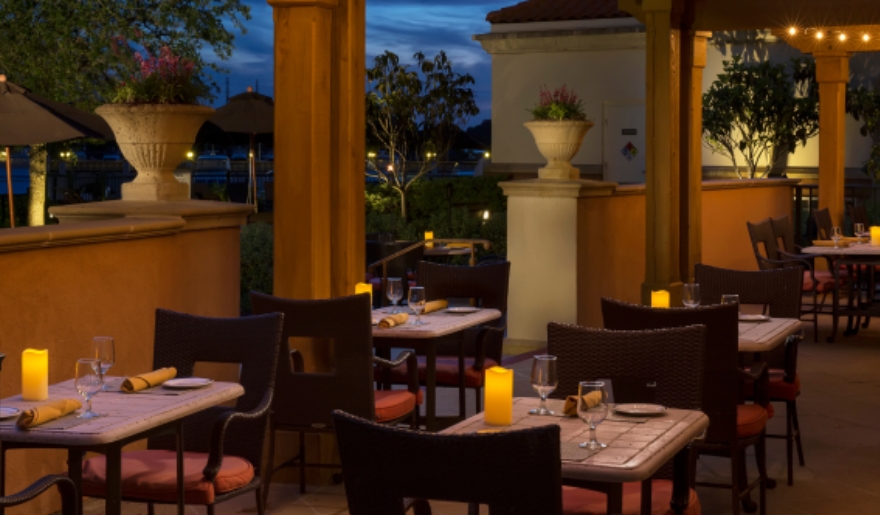 Restaurant patio adorned with tables and chairs, perfect for enjoying a romantic meal in Myrtle Beach.