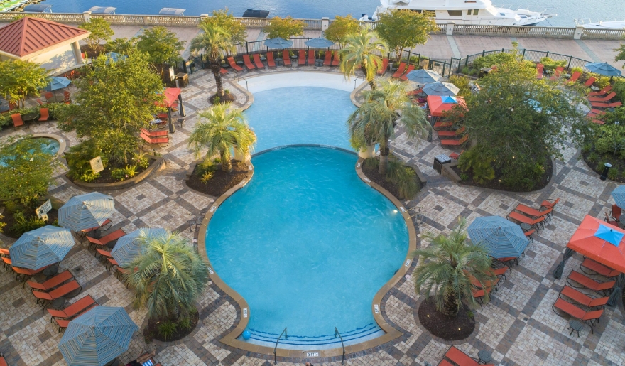 A serene pool area with lounge chairs and umbrellas, inviting relaxation at Marina Inn at Grande Dunes, Myrtle Beach.
