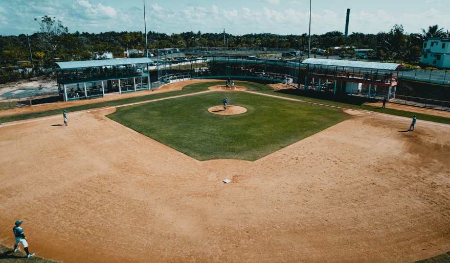 A baseball field featuring a diamond, set in Myrtle Beach, where fans cheer for the Myrtle Beach Pelicans in August.