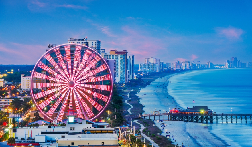 Myrtle Beach Boardwalk during Hot Summer Nights in August, showcasing vibrant crowds and festive atmosphere.