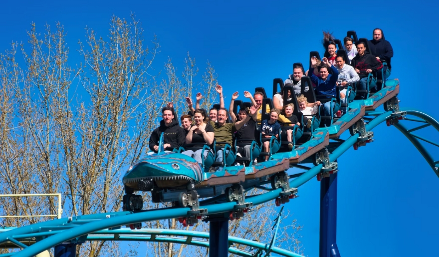 A group of excited people enjoying a roller coaster ride at Family Kingdom in Myrtle Beach during June.