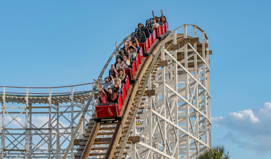 Riders on a roller coaster at Family Kingdom amusement park in Myrtle Beach, captured during a sunny June day.