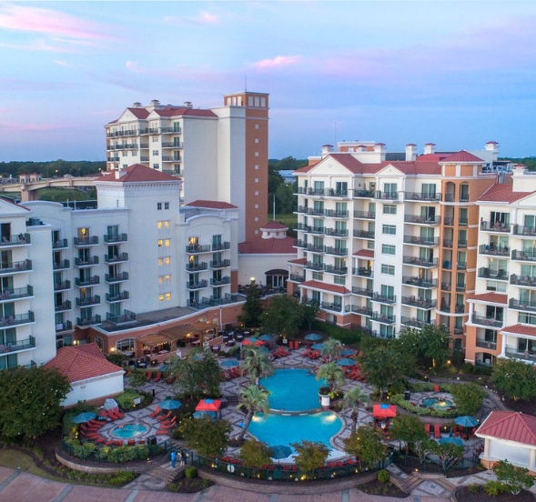Scenic sunset at a Myrtle Beach resort, showcasing a pool and patio, perfect for birthday celebrations.