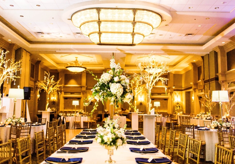 A birthday party reception featuring elegant gold and blue decor in an indoor event room at a Myrtle Beach venue.