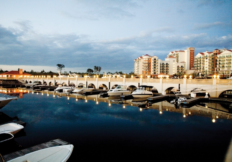 A marina with boats docked in front of the Marina-View Terraces, a birthday party venue in Myrtle Beach, SC.