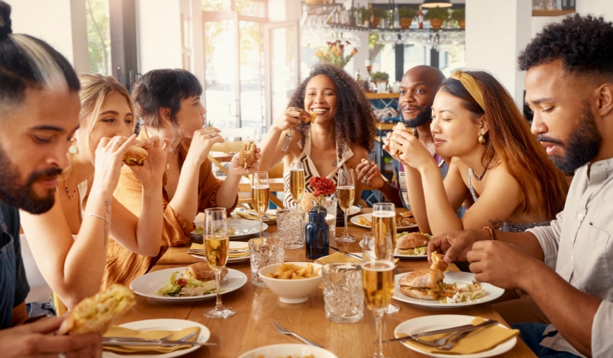 A group of people enjoying a meal together at a restaurant during the holidays in Myrtle Beach, Broadway at the Beach.
