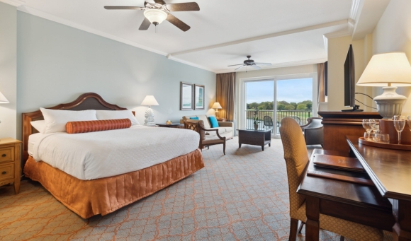 Luxurious hotel room in Myrtle Beach, equipped with a king bed and a flat-screen TV, perfect for honeymooners.