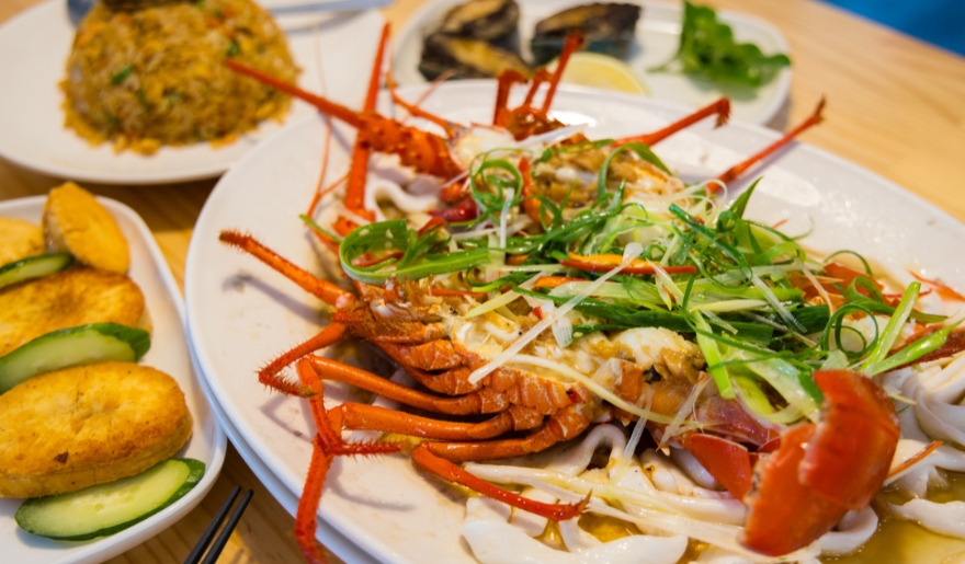 A plate of lobster and assorted seafood displayed on a table, part of a Myrtle Beach morning itinerary.