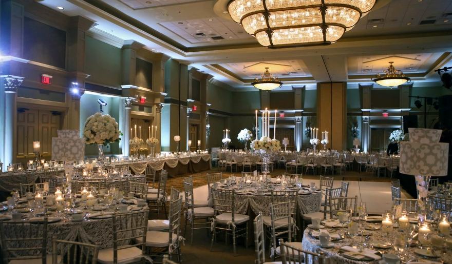An elegant banquet room featuring white and silver decor, ideal for wedding celebrations at Marina Inn, Grande Dunes.
