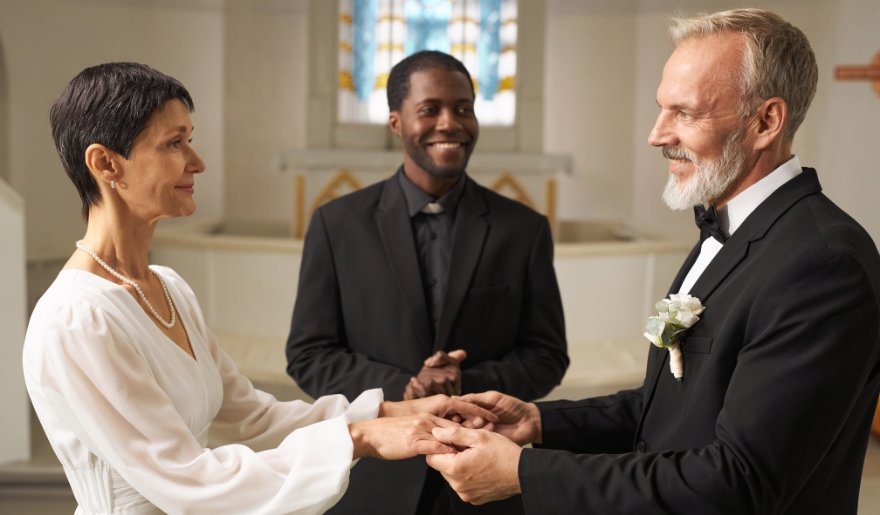 A man and woman exchange wedding rings during a ceremony at Wedding Chapel by the Sea in Myrtle Beach, SC.