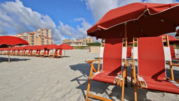 Beach chairs and vibrant umbrellas arranged on the sand, highlighting the private beach access at an Autism Friendly Hotel in Myrtle Beach.