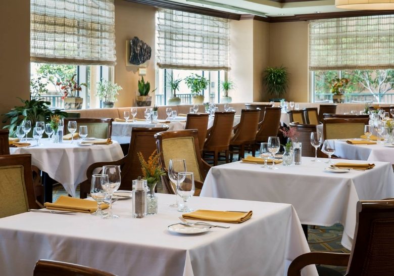 Restaurant interior showcasing tables and chairs set for dining, designed for families at a Myrtle Beach resort.