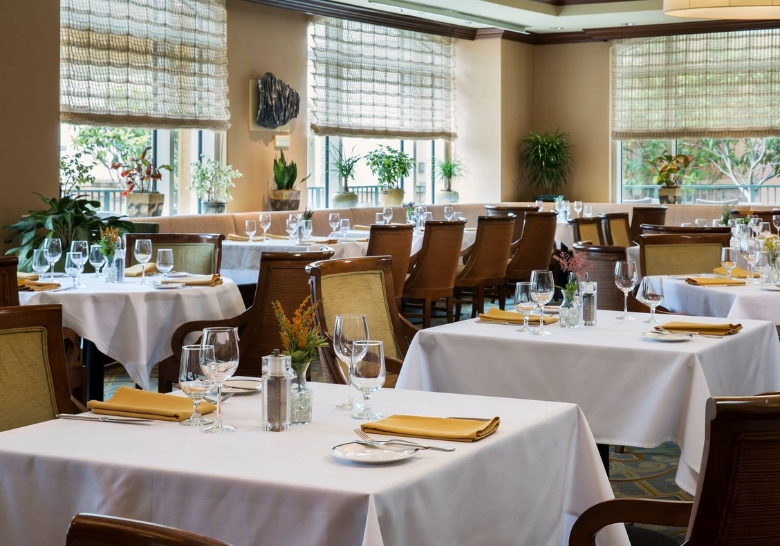 Restaurant interior showcasing tables and chairs set for dining, designed for families at a Myrtle Beach resort.