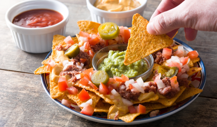 Delicious nachos accompanied by guacamole and salsa, representing sensory-friendly restaurant choices in Myrtle Beach.