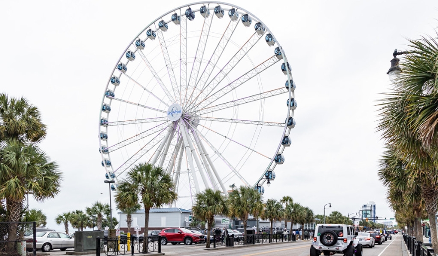 The SkyWheel, a large Ferris wheel, towers over the city of Myrtle Beach, promoting an autism-friendly environment.