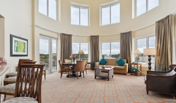 Spacious hotel living room with large windows, showcasing a bright and inviting atmosphere for families at Myrtle Beach.