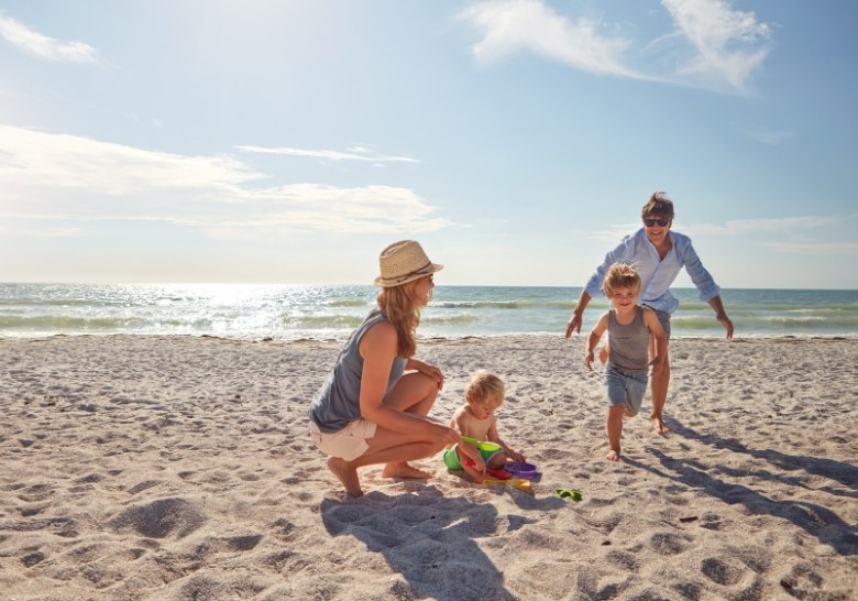 Family enjoying sunny day on Myrtle Beach near oceanfront condos close to attractions