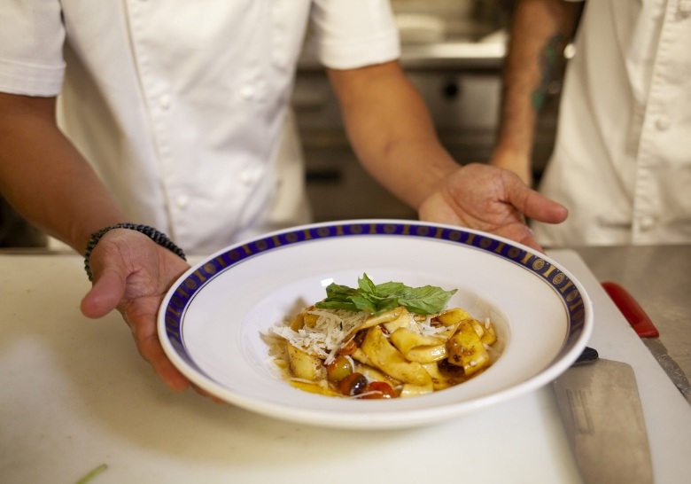 Chef preparing gourmet dish at Myrtle Beach resort offering luxury dining amenities for guests