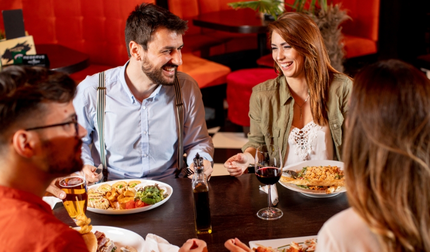 A group of people enjoying a meal together at a table, showcasing local dining experiences in Myrtle Beach.
