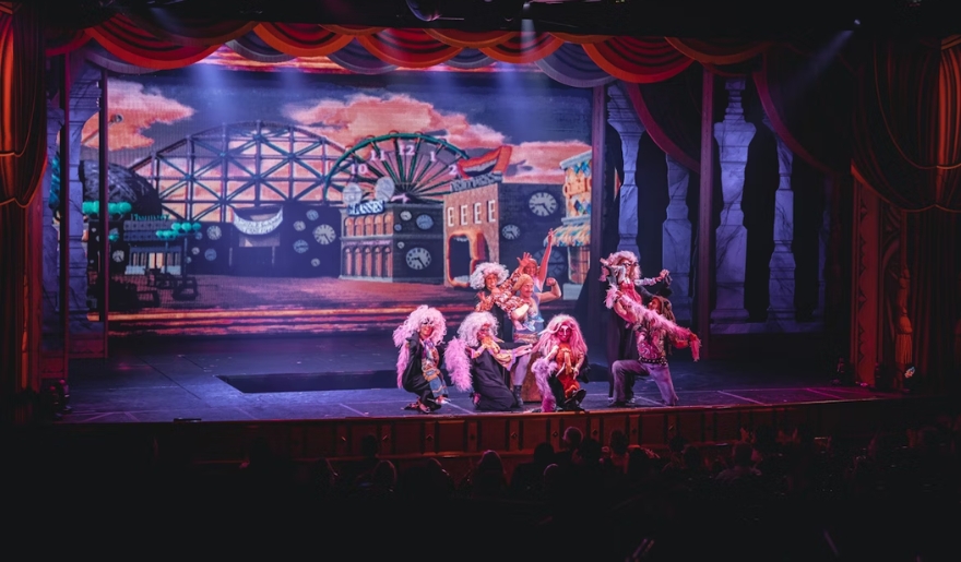 The cast of a live show performing on stage at a theater in Myrtle Beach, showcasing entertainment and group activities.
