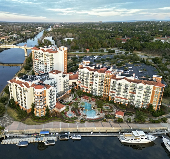 Overhead view of a marina and nearby apartment buildings, highlighting Myrtle Beach Hotel for Large Groups.