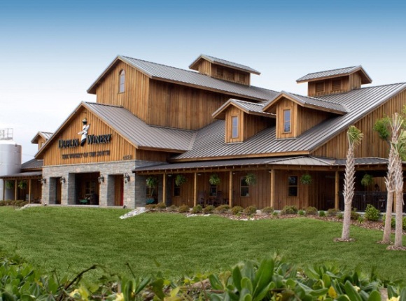 A charming barn located at a beach farm, offering a studio deluxe living space with a king bed and a cozy fireplace.