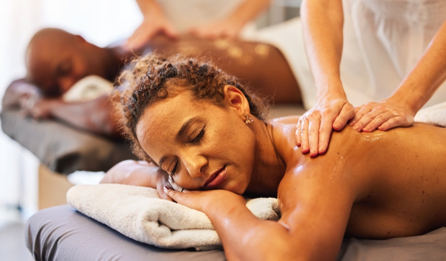 A woman enjoys a relaxing massage in a serene spa setting at Marina Inn.