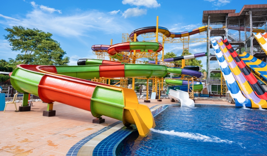 A lively water park scene at Currents Waterparks, showcasing bright slides and attractions in Myrtle Beach.
