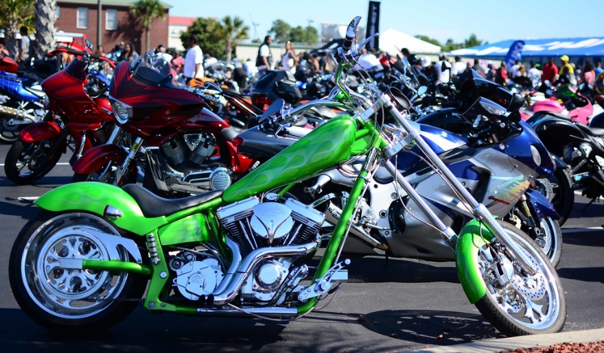 A different motorcycles are parked in a parking lot at Myrtle Beach, showcasing the atmosphere of the October Fall Rally.