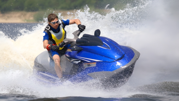 A man riding a jet ski on the water near Myrtle Beach, showcasing the excitement of jet ski rentals.