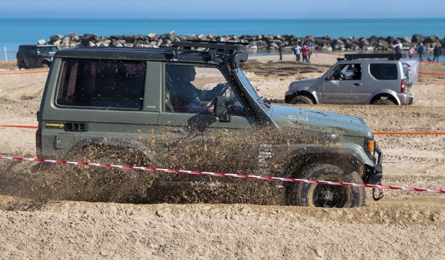 A jeep driving through the sand at Myrtle Beach during the Jeep Jam event in November.