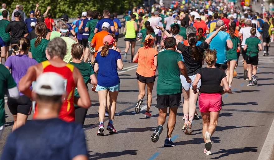 A group of runners participating in the Myrtle Beach Mini Marathon on a sunny November day.