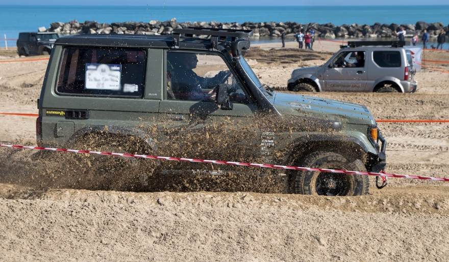 A jeep traversing the beach sand at Myrtle Beach, showcasing the excitement of the October Jeep Jam event.