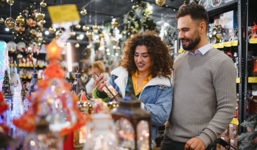 A man and woman browse Christmas decorations at the Myrtle Beach Holiday Market in The Market Common.