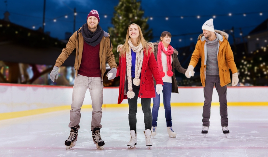 A group of four enjoys ice skating at Myrtle Beach's Winter Wonderland, capturing the holiday spirit of Christmas.