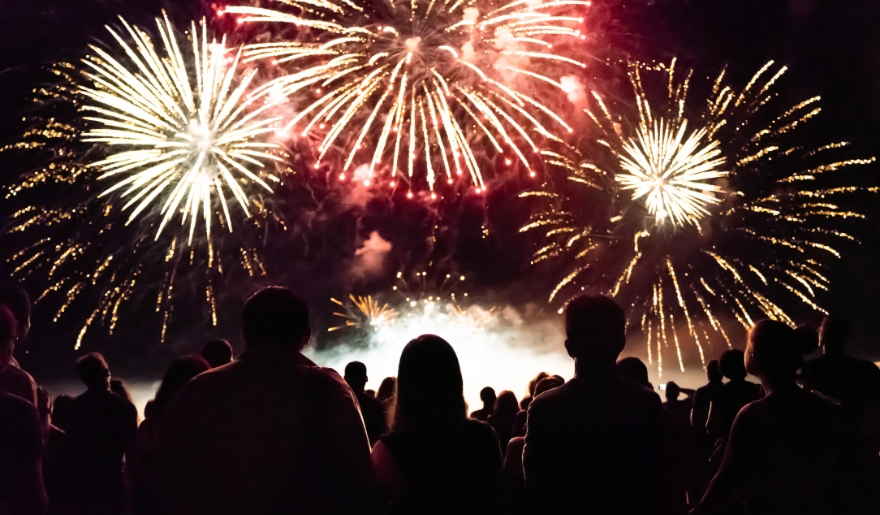A group of people enjoying fireworks on the beach during Myrtle Beach's New Year’s Eve celebration at Broadway at the Beach.